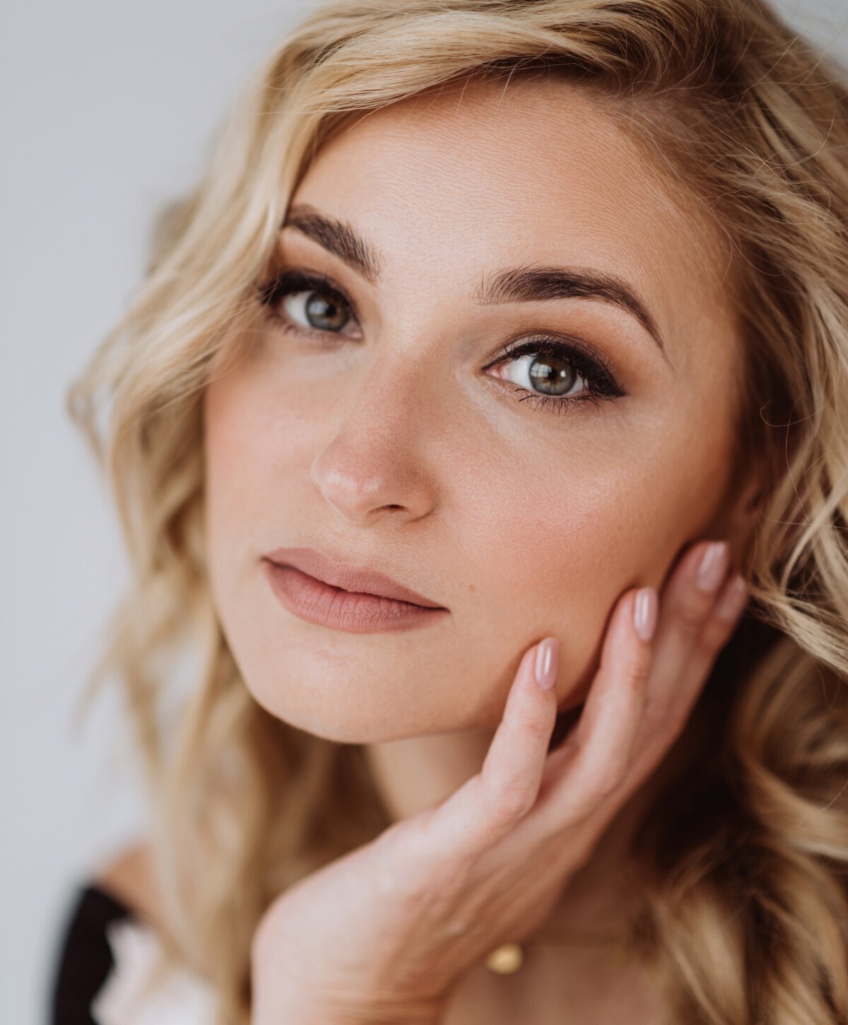 Virginia Beach Dermal Fillers model with blonde hair and hand on face